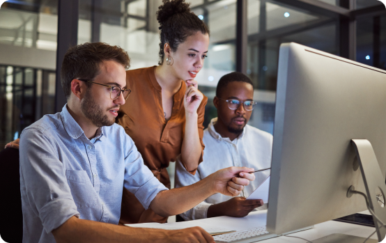 Accessibility specialists collaborating at a computer during manual accessibility testing and quality review.